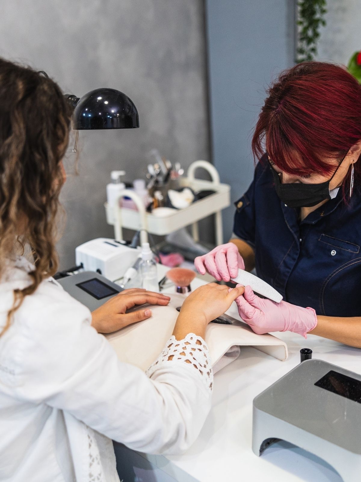 A nail technician at work