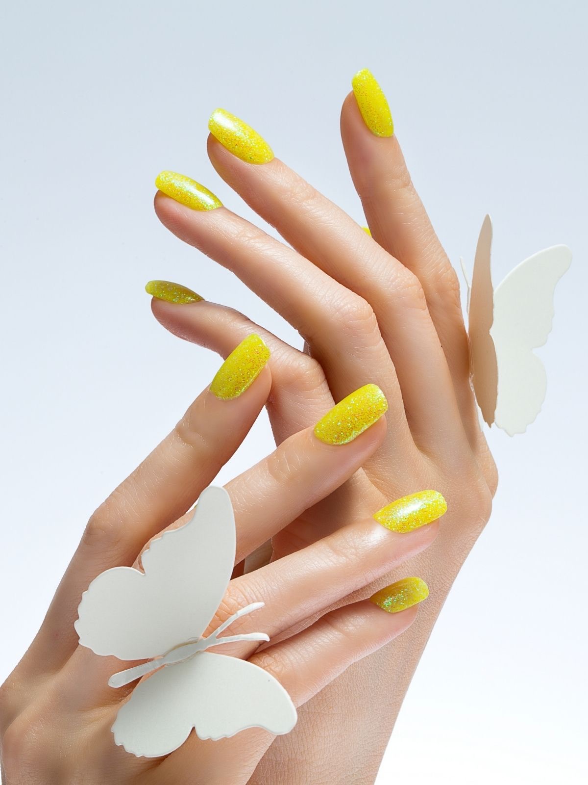 Playful yellow glitter butterfly nail art